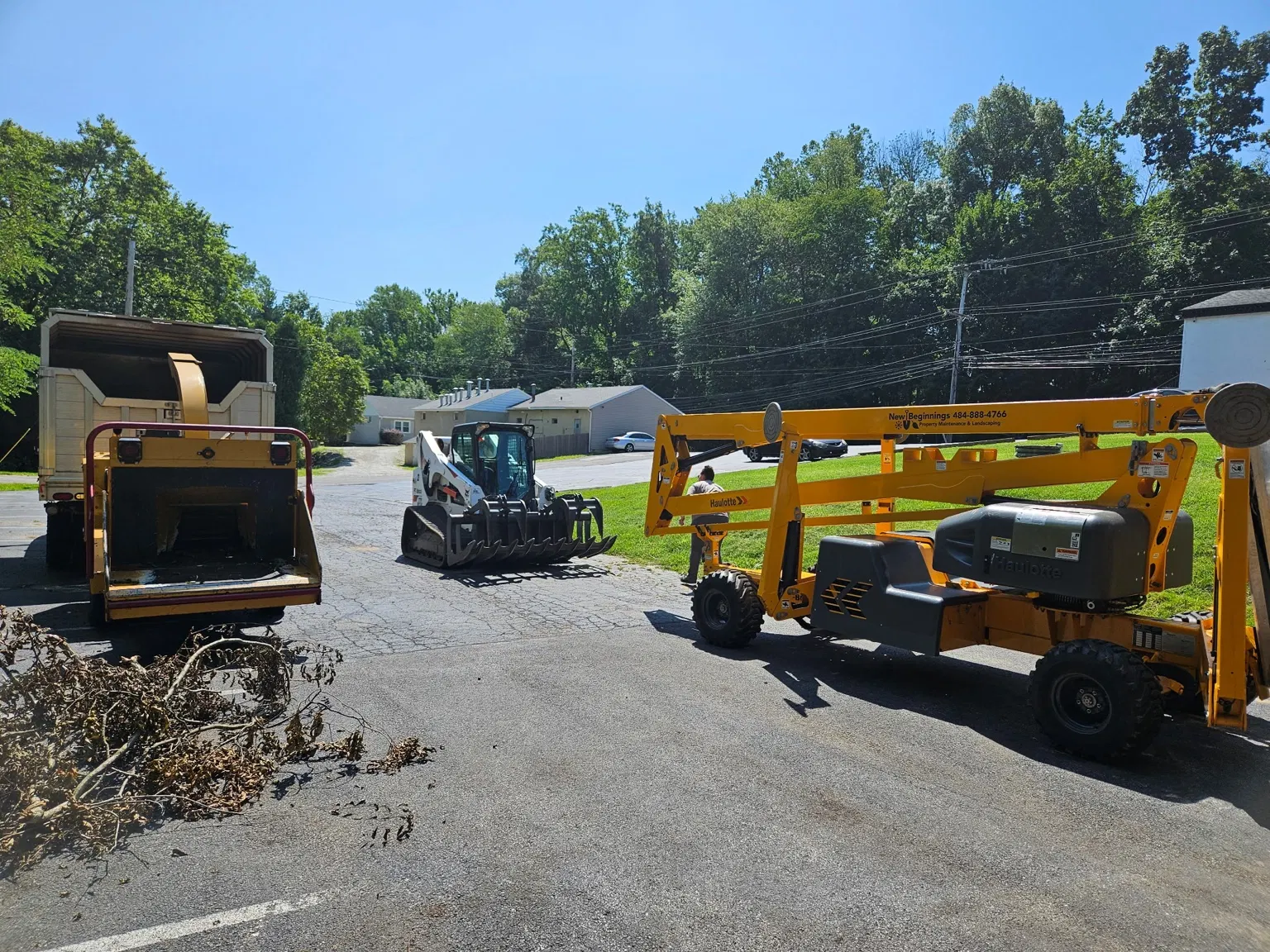 Wood chipper, lift and tracked loader assembled for tree work